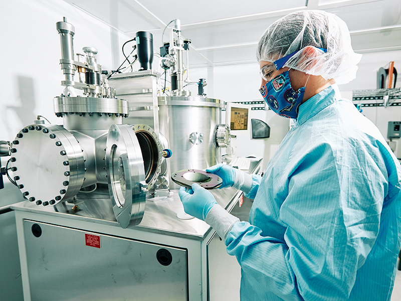 Male student lab worker using lab equipment