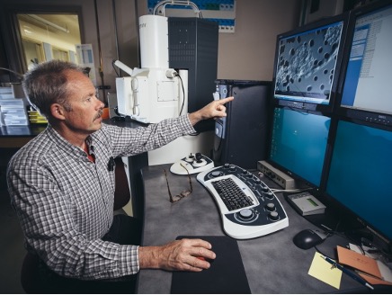 Inskeep sitting at computer monitors