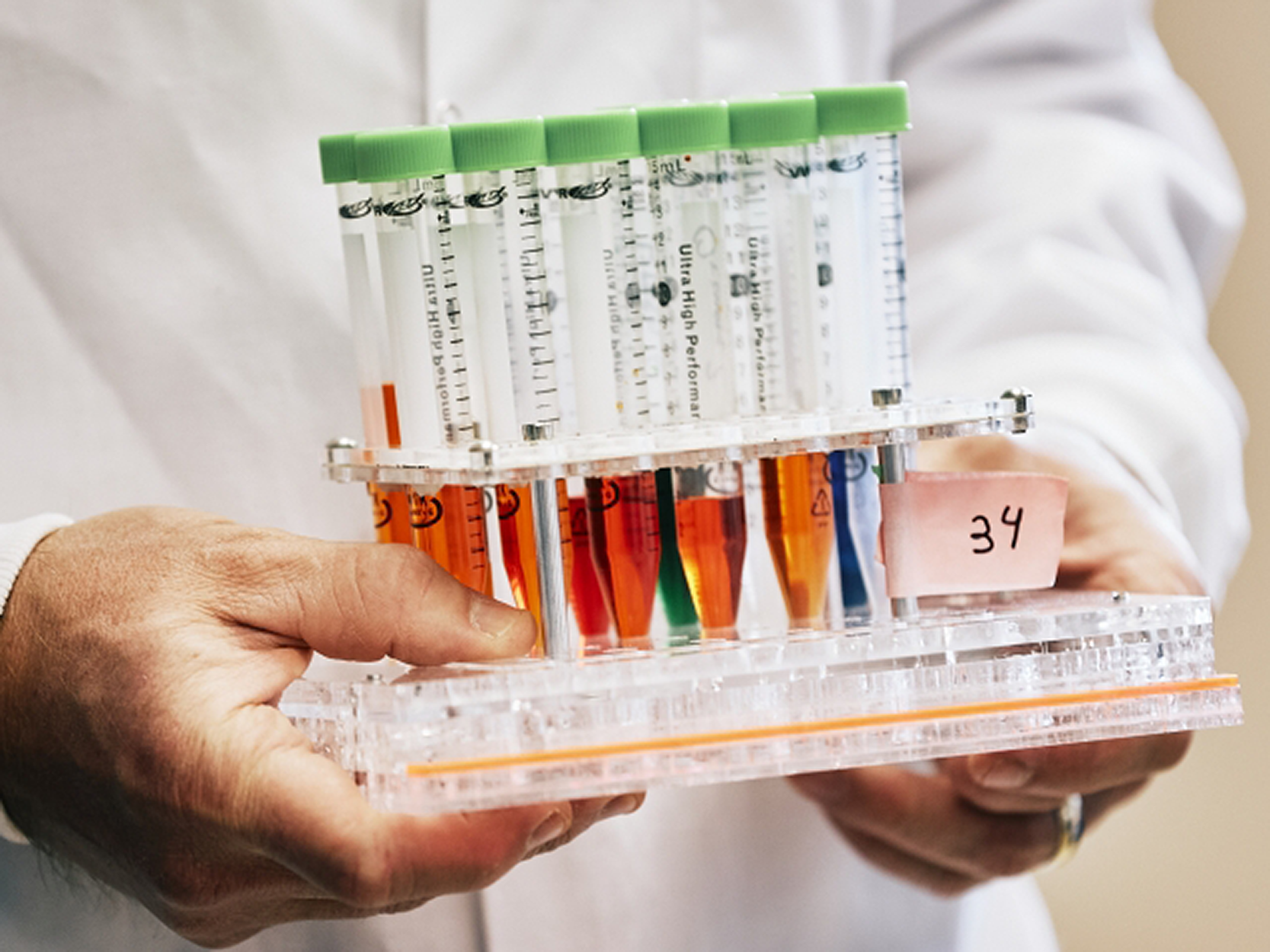 Scientist holding covid test tubes